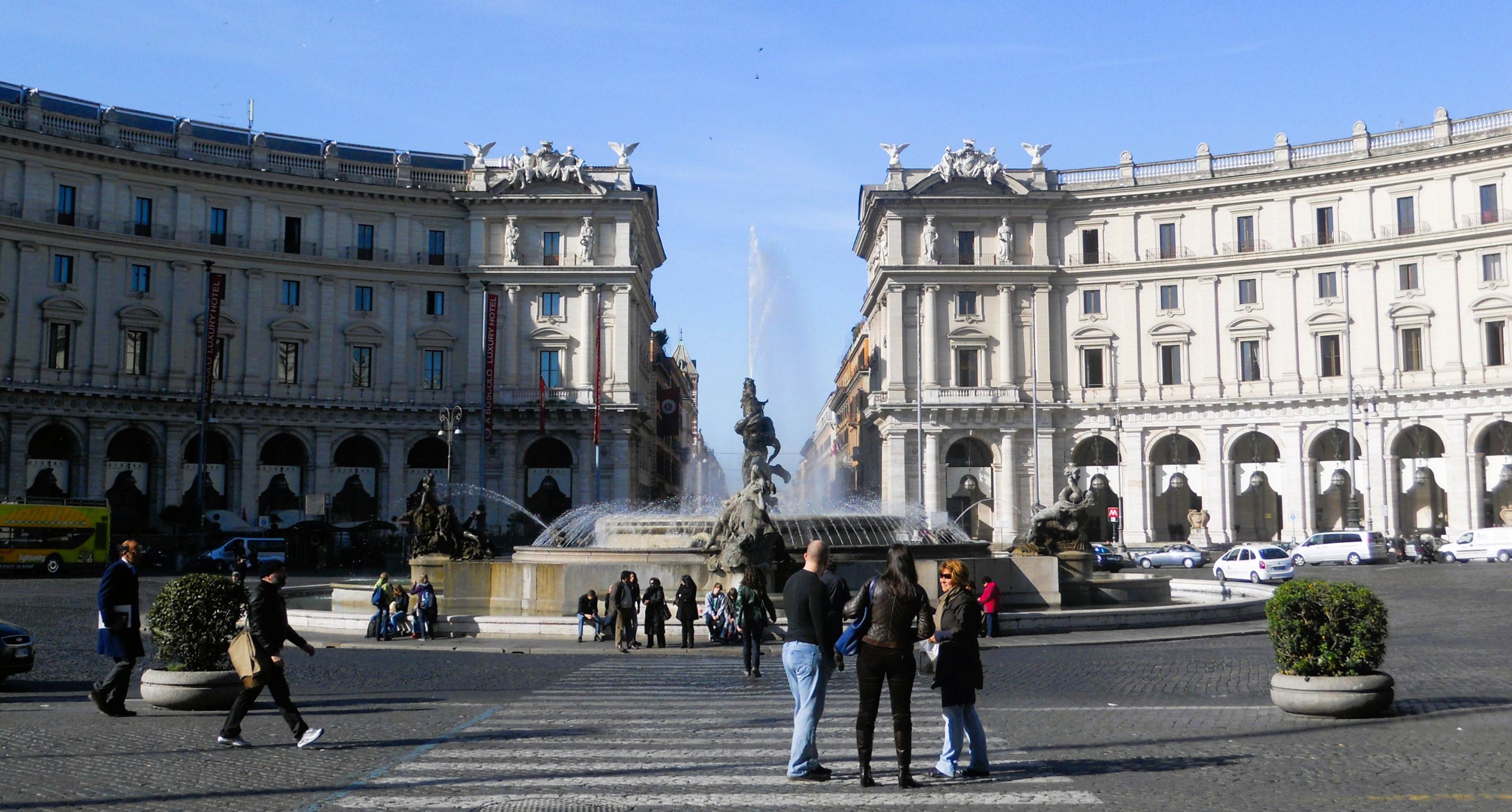 group of tourists admiring the fountain of naiads in piazza della repubblice, rome